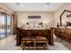 Well-lit main bedroom showcasing decorative bed frame, bench, and outdoor views at 38106 N 2Nd Ln, Phoenix, AZ 85086