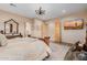 Bright main bedroom with decorative ceiling fan, door to bathroom, and desert themed TV at 38106 N 2Nd Ln, Phoenix, AZ 85086