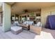 Relaxing covered patio featuring stylish wicker furniture, a ceiling fan, and outdoor entertainment setup at 38106 N 2Nd Ln, Phoenix, AZ 85086