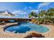 Beautiful backyard oasis featuring a freeform pool, waterfall, lush tropical landscaping, and comfortable seating at 38106 N 2Nd Ln, Phoenix, AZ 85086
