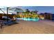 Stunning backyard pool area with lush landscaping, a charming waterfall feature, and a cozy fire pit at 38106 N 2Nd Ln, Phoenix, AZ 85086