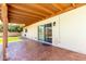Charming covered back patio featuring brick flooring and a sliding glass door entrance to the home at 3913 N 86Th St, Scottsdale, AZ 85251