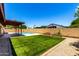 Landscaped backyard featuring lush green turf, a sparkling pool, and a covered patio for relaxation and entertainment at 3913 N 86Th St, Scottsdale, AZ 85251