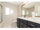 Bright bathroom showcasing a vanity with a white countertop and a decorative mirror frame at 3913 N 86Th St, Scottsdale, AZ 85251