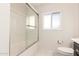 Bathroom featuring a tiled shower with a sliding glass door and a window for natural light at 3913 N 86Th St, Scottsdale, AZ 85251