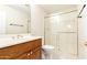 Well-lit bathroom featuring a vanity with a sink and a glass-enclosed shower at 3913 N 86Th St, Scottsdale, AZ 85251