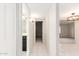 Bright hallway leading to a bathroom, with tiled floors and neutral paint at 3913 N 86Th St, Scottsdale, AZ 85251