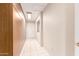 Tiled hallway with ample built-in storage cabinets and a doorway at the end at 3913 N 86Th St, Scottsdale, AZ 85251