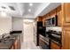 Close-up of updated kitchen, showcasing stainless steel appliances and dark granite countertops at 3913 N 86Th St, Scottsdale, AZ 85251