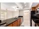 Modern kitchen with breakfast bar, stainless appliances, dark counters, and an open floor plan at 3913 N 86Th St, Scottsdale, AZ 85251