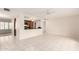 Spacious living room showcasing an open floor plan into the kitchen with white tile floors at 3913 N 86Th St, Scottsdale, AZ 85251