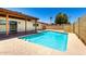 Backyard view showcasing the sparkling swimming pool, patio area, and well-maintained perimeter block fence at 3913 N 86Th St, Scottsdale, AZ 85251