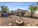 An inviting backyard featuring a fire pit, covered patio, and desert-style landscaping at 3955 W Cindy St, Chandler, AZ 85226