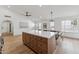 Open kitchen and dining area with a large kitchen island, stainless steel appliances, and hardwood floors at 3955 W Cindy St, Chandler, AZ 85226
