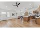 Spacious living area with light wood flooring, white walls, and a kitchen island with light-colored wood cabinets at 3955 W Cindy St, Chandler, AZ 85226