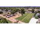 Spacious horse property featuring a large grassy field, stables, and riding area at 4145 W Banff Ln, Phoenix, AZ 85053