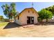 Tan barn featuring a sliding door and brick flooring with a nearby tree for shade at 4145 W Banff Ln, Phoenix, AZ 85053