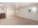 Finished basement offers a spacious area with neutral carpet, bright white walls, and window at 4145 W Banff Ln, Phoenix, AZ 85053