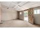 This unfinished basement is well-lit and shows the door to the backyard at 4145 W Banff Ln, Phoenix, AZ 85053