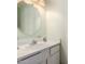 Simple bathroom featuring a white vanity with a round mirror and soft lighting at 4145 W Banff Ln, Phoenix, AZ 85053