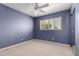 Serene bedroom with a ceiling fan, shutters, and ample natural light at 4145 W Banff Ln, Phoenix, AZ 85053