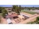 Aerial view showcases well-maintained horse facilities with stables, paddocks, and riding area at 4145 W Banff Ln, Phoenix, AZ 85053