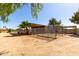 View of horse pens on a dirt lot with some shade from a tree and a nearby building at 4145 W Banff Ln, Phoenix, AZ 85053