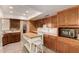Functional kitchen with wooden cabinets, ample counter space, and a movable kitchen island at 4145 W Banff Ln, Phoenix, AZ 85053