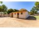 Side view of a small outbuilding featuring an open dirt lot and two windows at 4145 W Banff Ln, Phoenix, AZ 85053