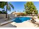 Beautiful pool and patio with palm trees and water features make this a backyard oasis at 4145 W Banff Ln, Phoenix, AZ 85053