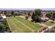 Large grassy yard with horse facilities on a well-maintained property at 4145 W Banff Ln, Phoenix, AZ 85053