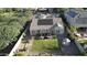 Aerial view of a backyard featuring a well-maintained lawn, covered patio, and solar panels on the roof at 4277 E Blue Sage Ct, Gilbert, AZ 85297