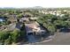 Aerial view showcasing neighborhood with desert landscaping, lush greenery, and mountain views at 4277 E Blue Sage Ct, Gilbert, AZ 85297