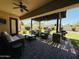 Covered back patio with ceiling fan and furniture, overlooking a well-maintained lawn and garden at 4277 E Blue Sage Ct, Gilbert, AZ 85297