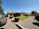Landscaped backyard featuring a grassy area, covered patio, and tasteful outdoor furniture for relaxation at 4277 E Blue Sage Ct, Gilbert, AZ 85297