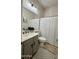 Neutral bathroom featuring a shower with a textured curtain, updated vanity, and modern fixtures at 4277 E Blue Sage Ct, Gilbert, AZ 85297