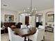 Elegant dining room with modern chandelier and views into the living room at 4277 E Blue Sage Ct, Gilbert, AZ 85297
