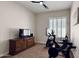 Functional exercise room featuring a Peloton bike, dresser, and large windows for natural light at 4277 E Blue Sage Ct, Gilbert, AZ 85297