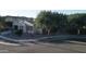 Street view of a single-story home with desert landscaping and mature trees at 4277 E Blue Sage Ct, Gilbert, AZ 85297