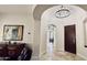 Chic foyer with curved archways, decorative lighting fixture, and dark wood front door at 4277 E Blue Sage Ct, Gilbert, AZ 85297