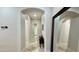 Hallway showcasing a mirror and archways leading to various rooms, with neutral walls and tile flooring at 4277 E Blue Sage Ct, Gilbert, AZ 85297