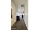 Hallway with carpeted floor leading to a room with plantation shutters and dresser at 4277 E Blue Sage Ct, Gilbert, AZ 85297