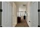 Hallway with carpeted floor leading to a room with plantation shutters and a dresser at 4277 E Blue Sage Ct, Gilbert, AZ 85297