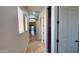 Bright hallway with tile flooring, natural light, and multiple doorways leading to different rooms at 4277 E Blue Sage Ct, Gilbert, AZ 85297