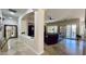 Spacious living room featuring tile flooring and natural light from multiple windows with plantation shutters at 4277 E Blue Sage Ct, Gilbert, AZ 85297