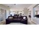 Spacious living room featuring a comfortable leather sofa and open view of the modern kitchen at 4277 E Blue Sage Ct, Gilbert, AZ 85297