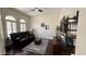 Comfortable living room featuring dark wood floors, plantation shutters, and cozy seating at 4277 E Blue Sage Ct, Gilbert, AZ 85297