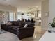 Inviting living room with a view of a well-equipped kitchen and a comfortable brown leather sofa at 4277 E Blue Sage Ct, Gilbert, AZ 85297