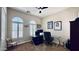 Well-lit office space with a modern desk, sports memorabilia, and shuttered windows at 4277 E Blue Sage Ct, Gilbert, AZ 85297