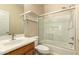 Bright bathroom featuring a shower and tub combo with glass door, a vanity, and towel rack at 4682 E Redfield Rd, Gilbert, AZ 85234
